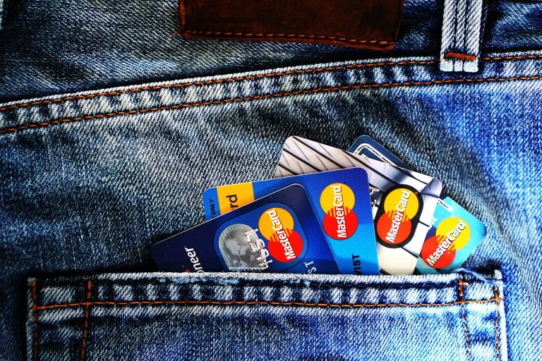 Close-up of a denim pocket with multiple credit cards, illustrating finance and fashion.