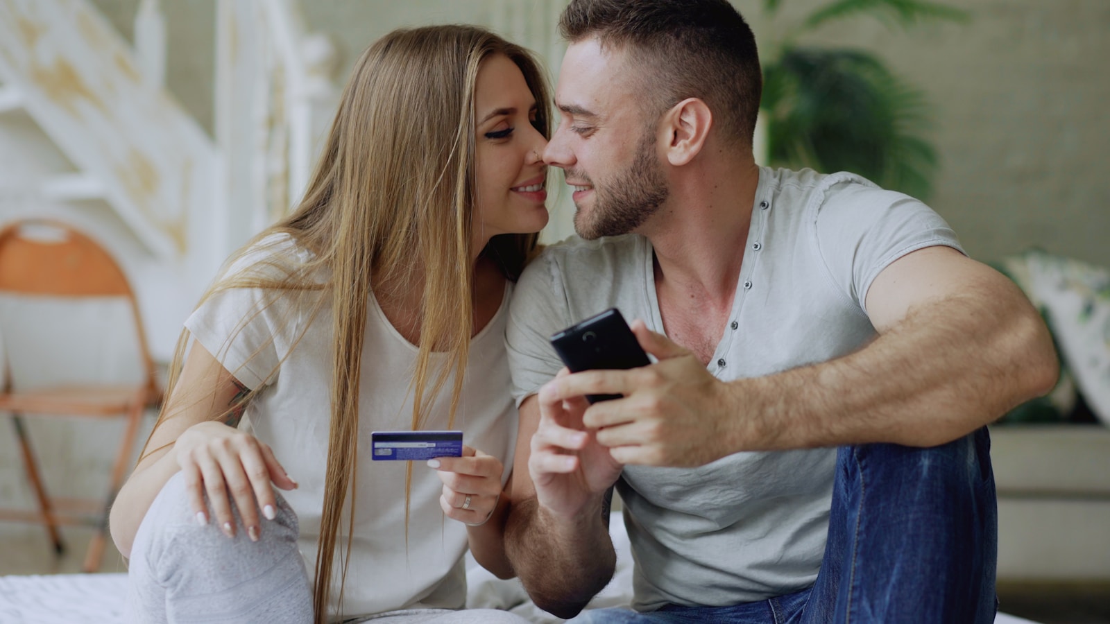 Couple holding credit card and smartphone