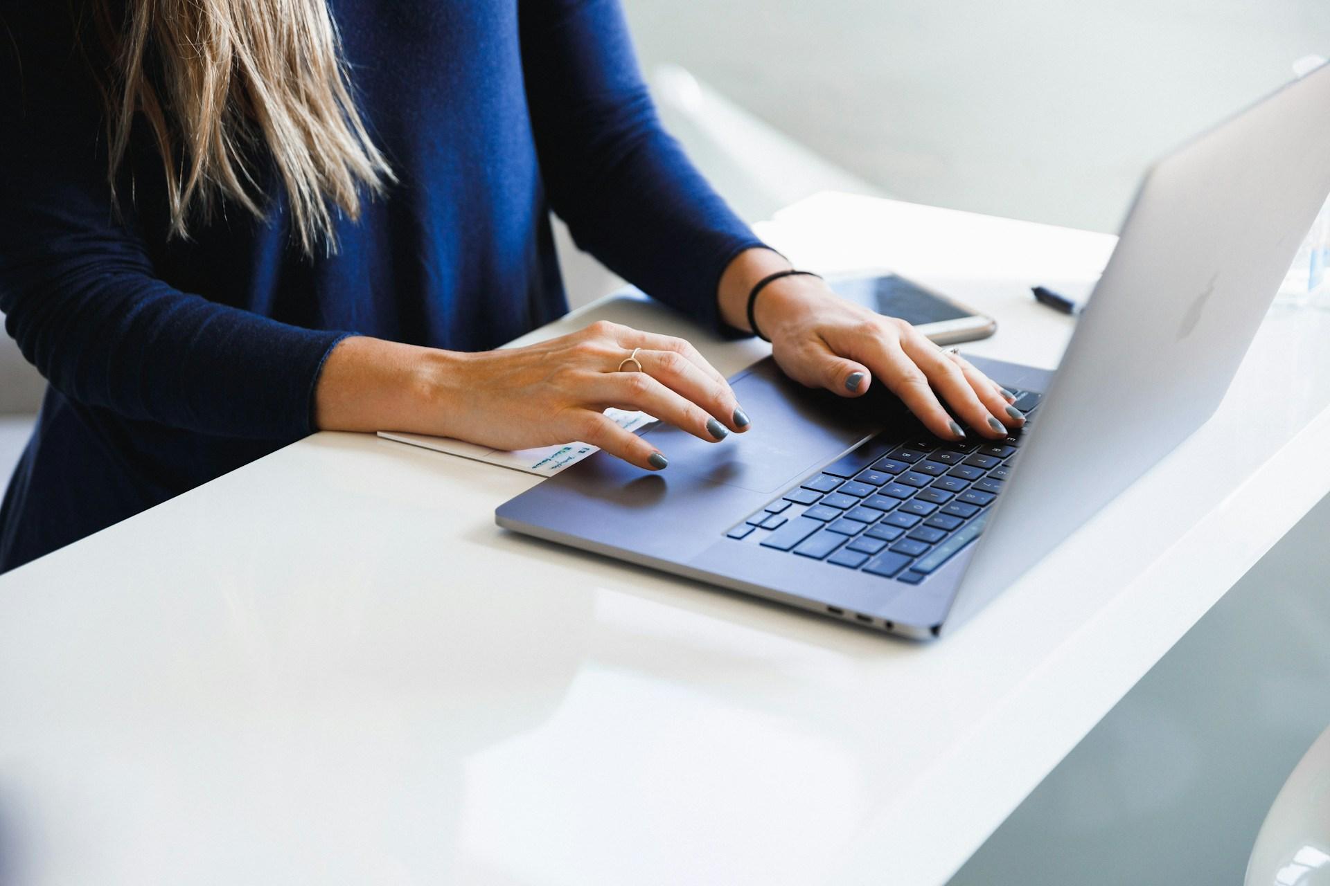 Woman working on a laptop at a desk