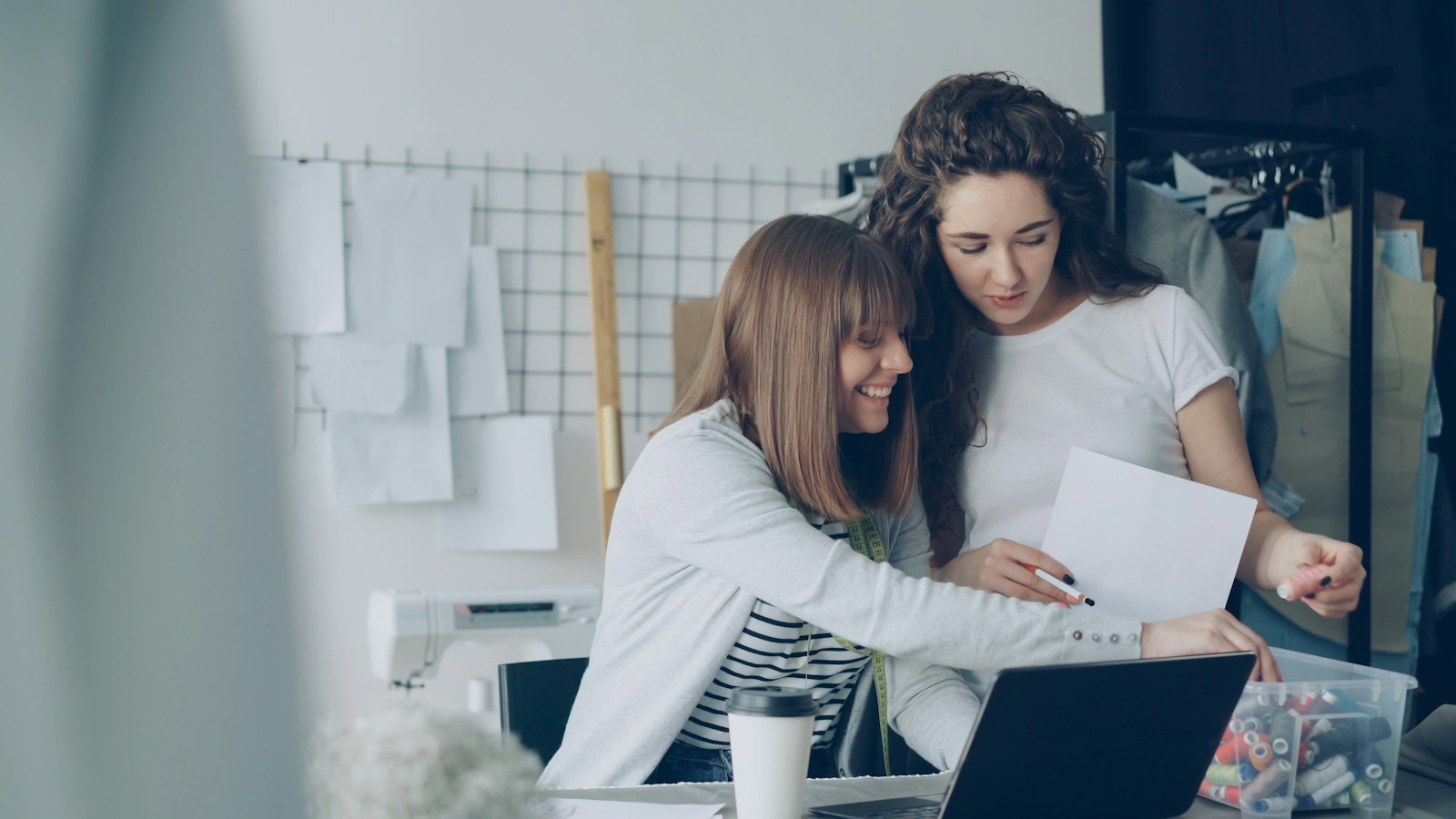 Two women are looking over papers